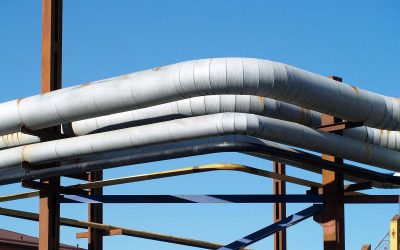 Des tuyaux blancs sur une structure métallique sous un ciel bleu